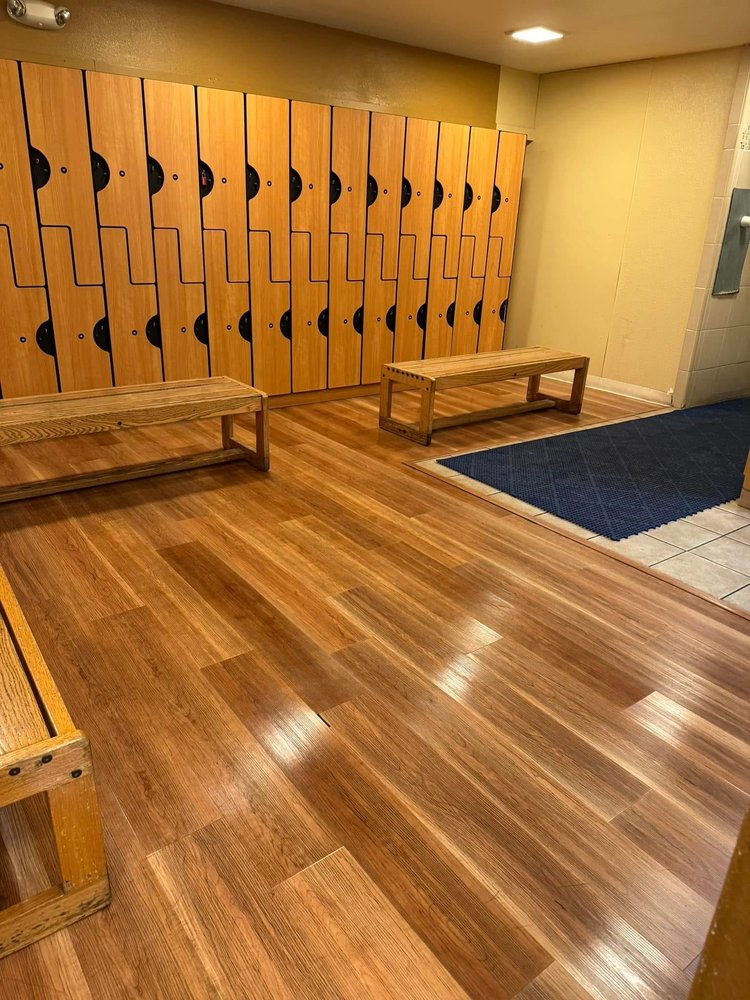 Warm wood locker room with freshly polished floors and benches